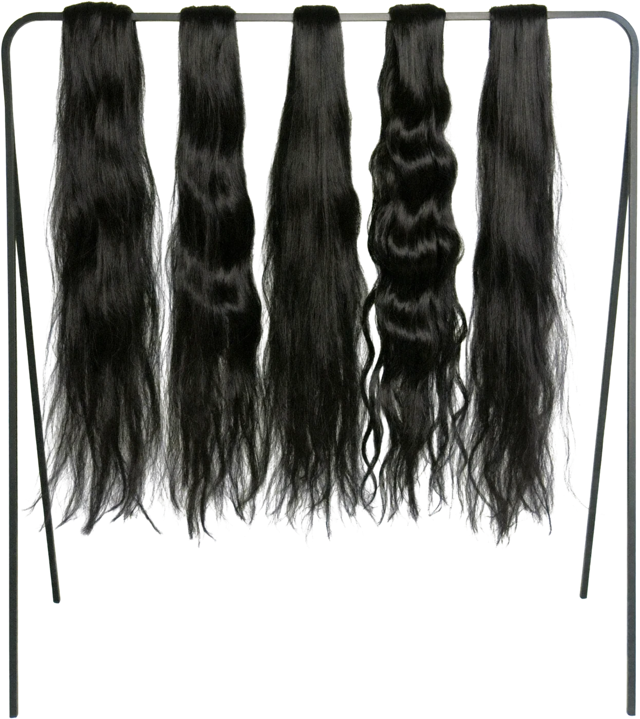 Five wavy hair bundles hanging on a studio rail